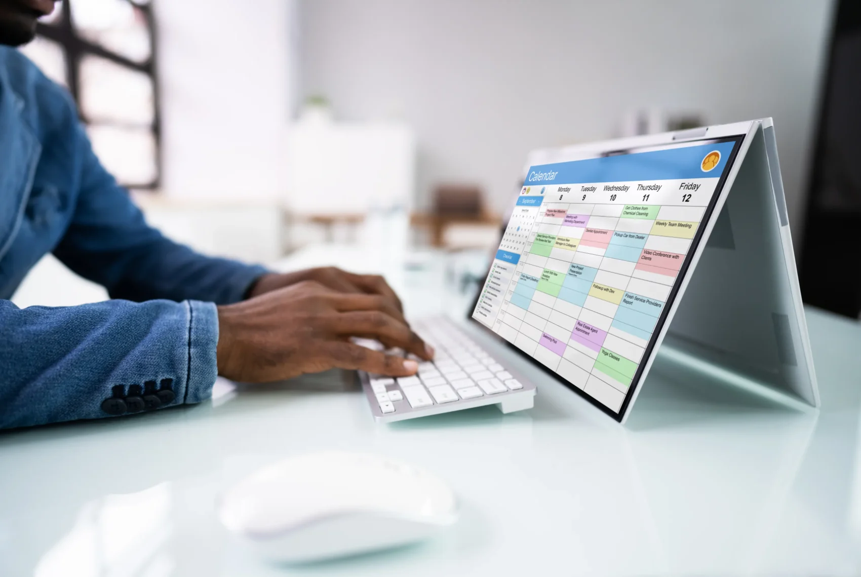 A person reviewing a calendar on a laptop while arranging an appointment