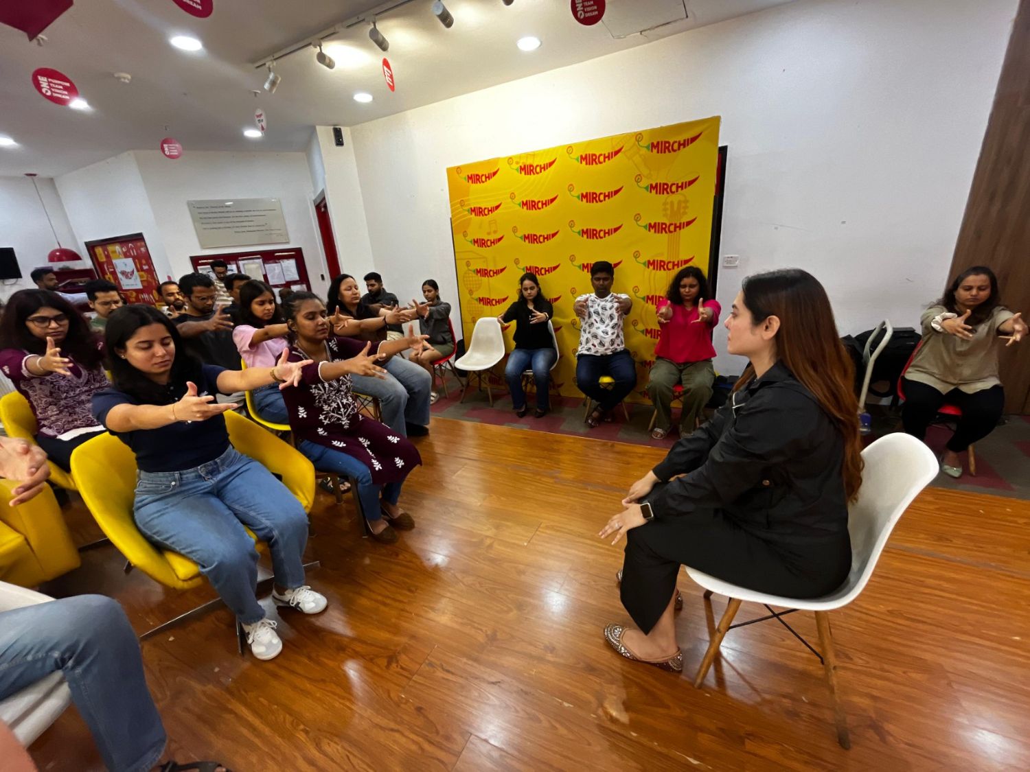 Vibha Jain leading a guided relaxation and awareness session with a seated group of participants in Mumbai